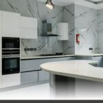 Family friendly kitchens featuring durable finishes and kid safe layouts with custom matte white shaker door cabinets and handles.
