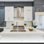 Guide to backsplash and countertop templating featuring custom shaker-door kitchens with matte white handles.
